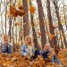 girls throwing autumn leaves in the park and having a good time