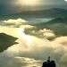 A breathtaking aerial view of the Albanian mountains and river at sunrise, highlighting nature's beauty.